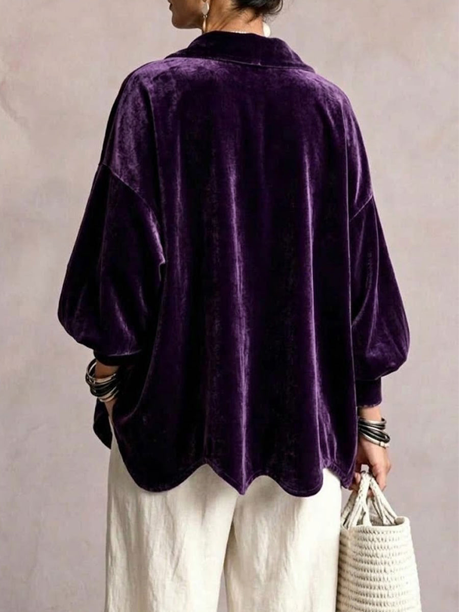 Back of the plum jacket showing lantern sleeves and scalloped hem
