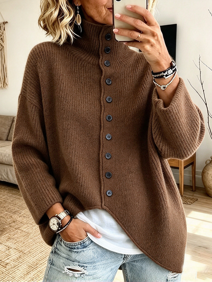 Brown oversized mock neck sweater worn over a white tee