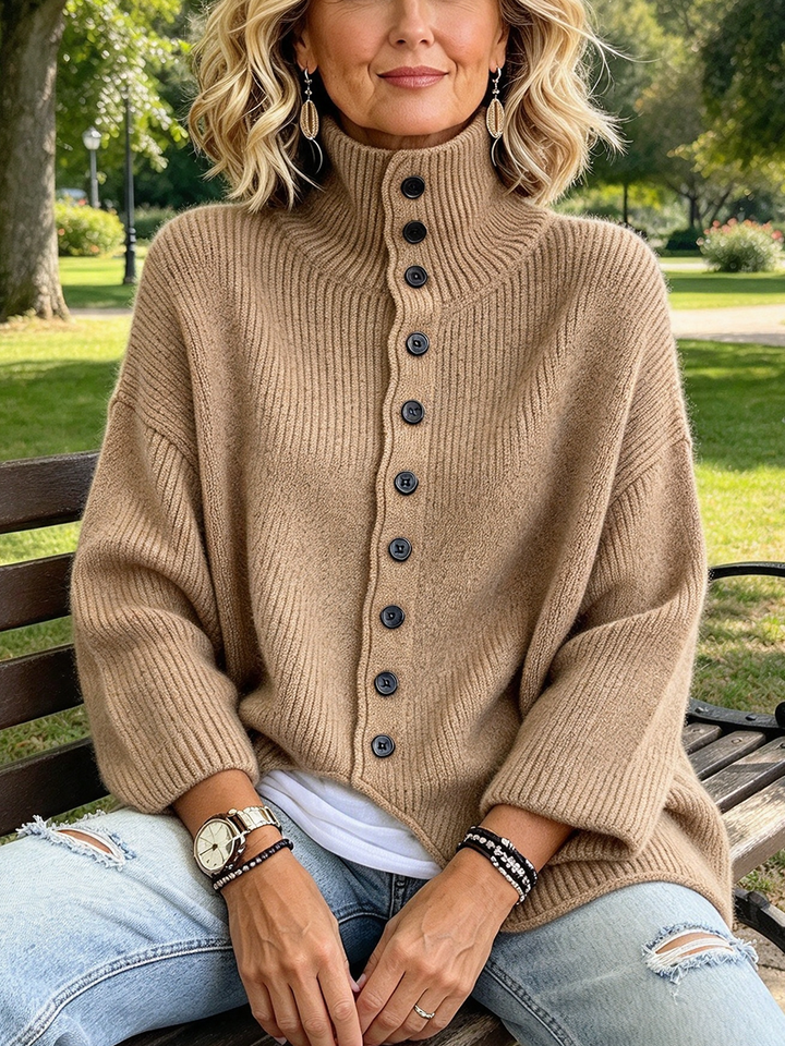 Woman sitting on a park bench in the camel oversized sweater