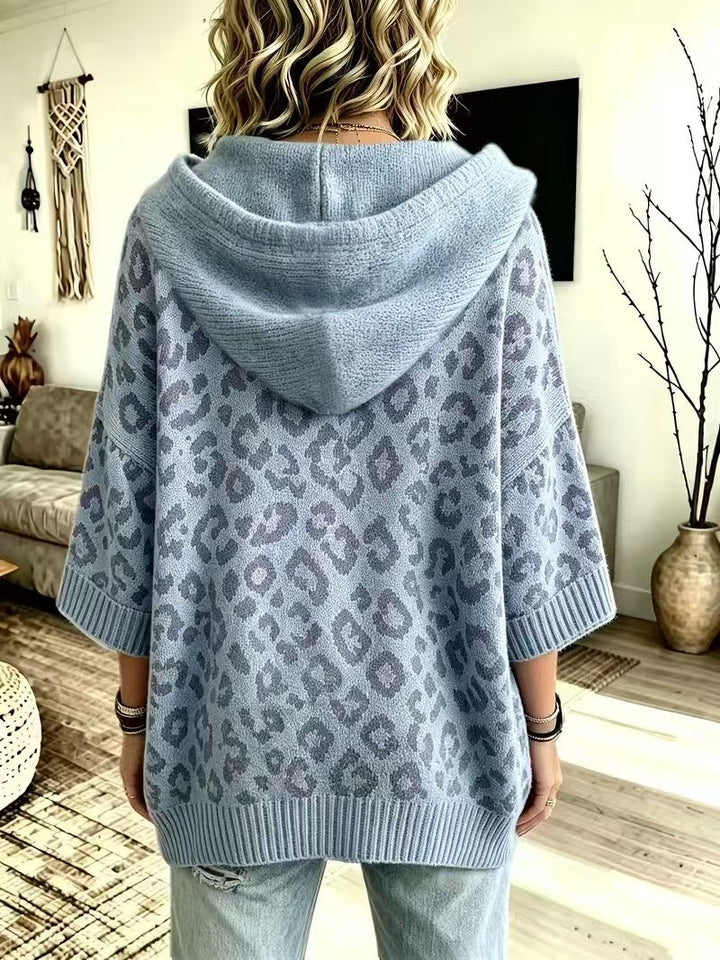 Back view of the dusty blue hooded sweater with ribbed hem