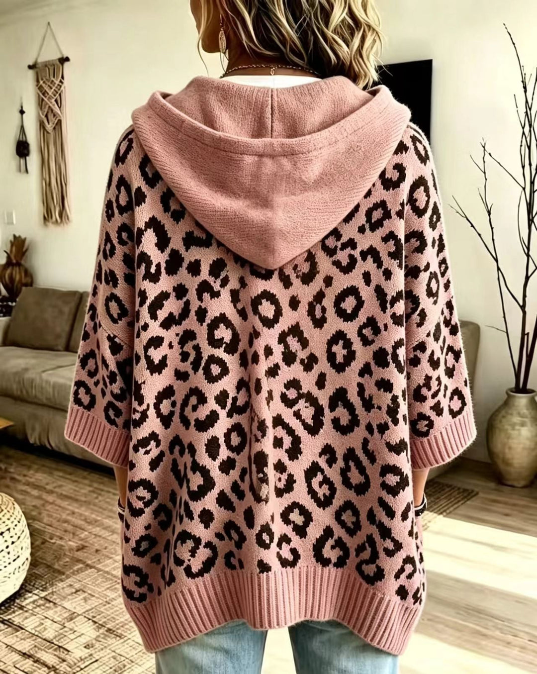 Dusty pink sweater seen from the back with the hood resting flat