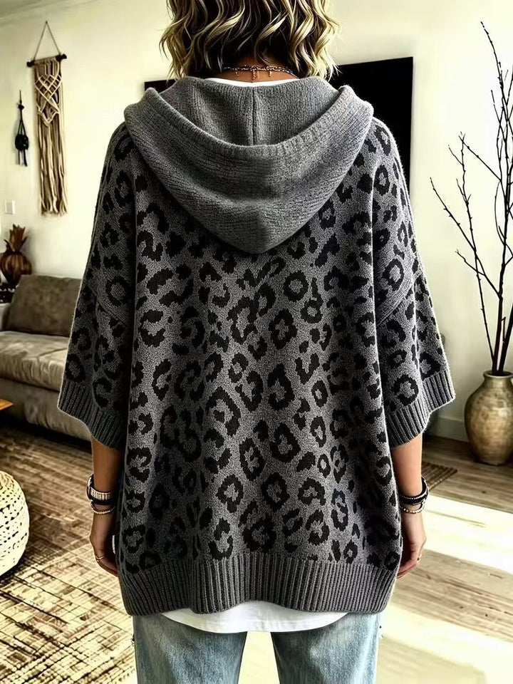 Back of the grey sweater showing the hood and wide body