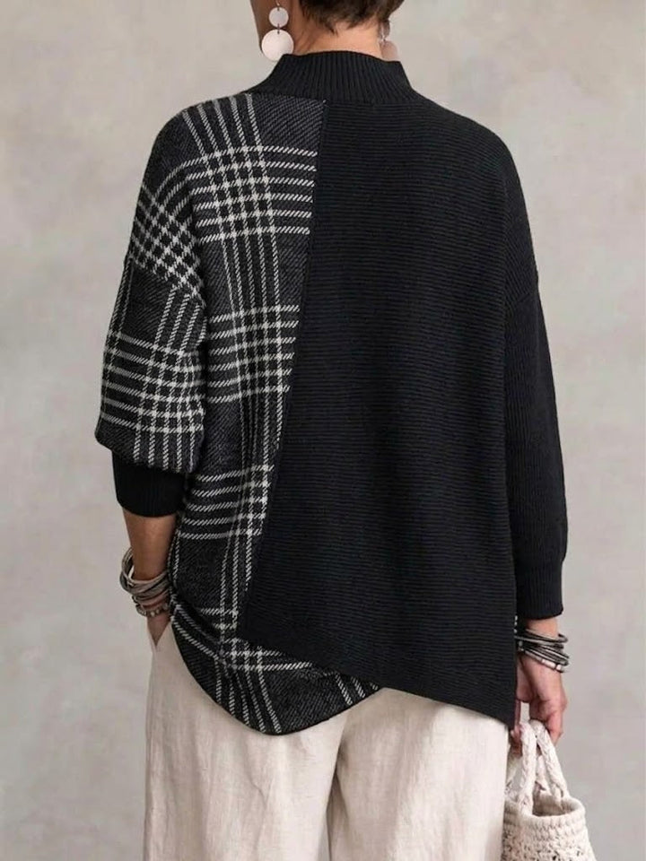 Back view showing the plaid knit panel and the curved, uneven hem