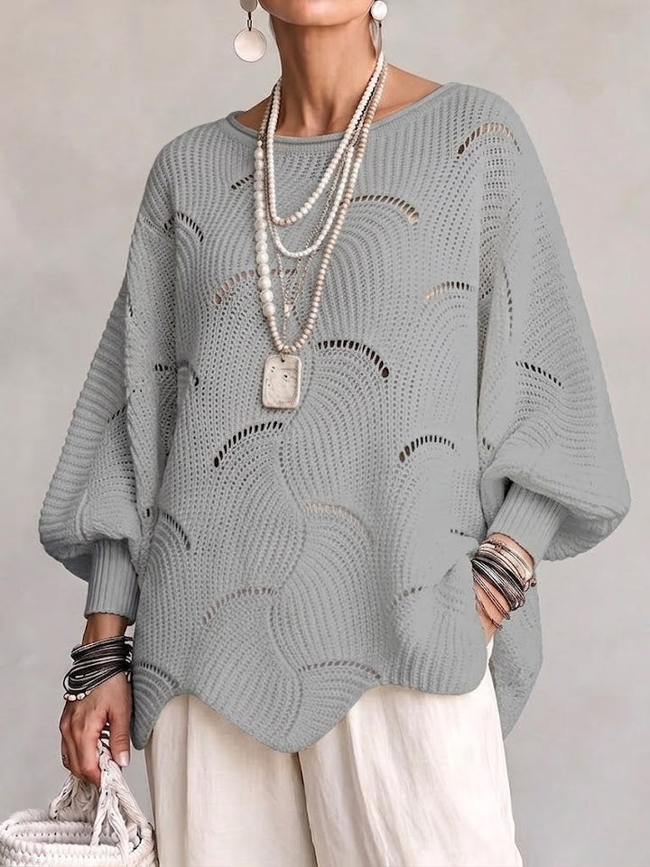 Gray openwork knit sweater with a wavy hem