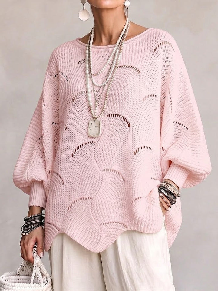 Pink oversized sweater with batwing sleeves and layered necklaces