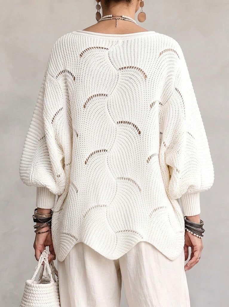 Back view of the white openwork sweater with its scalloped hem