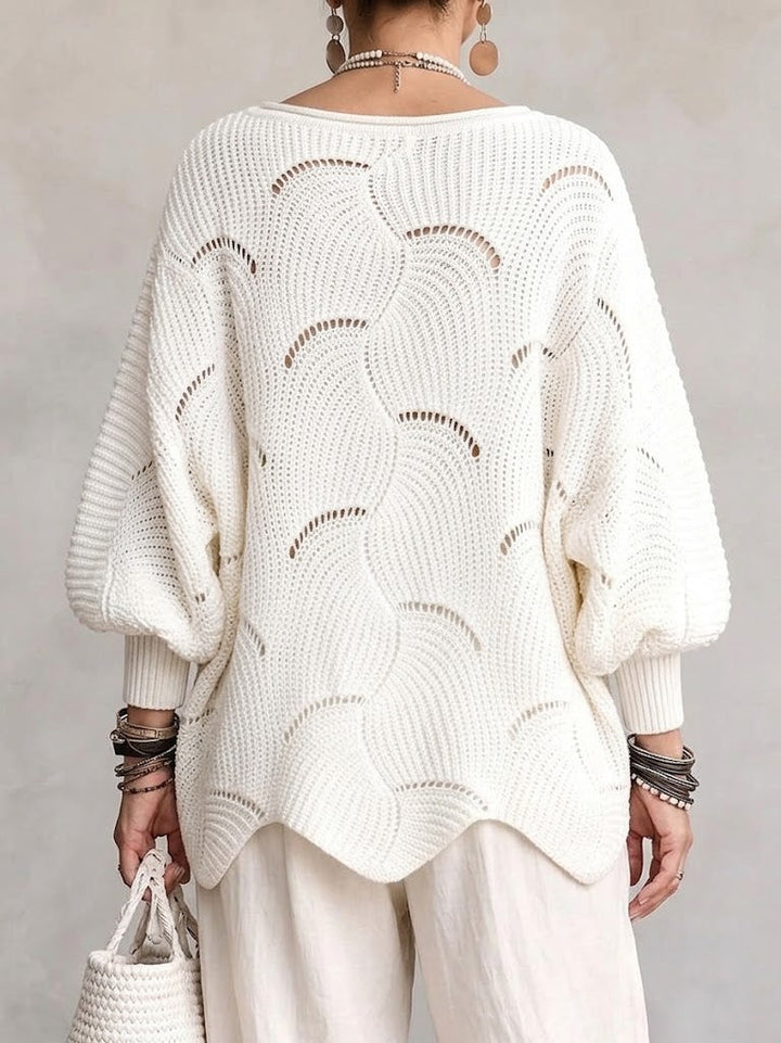 Back view of the white openwork sweater with its scalloped hem