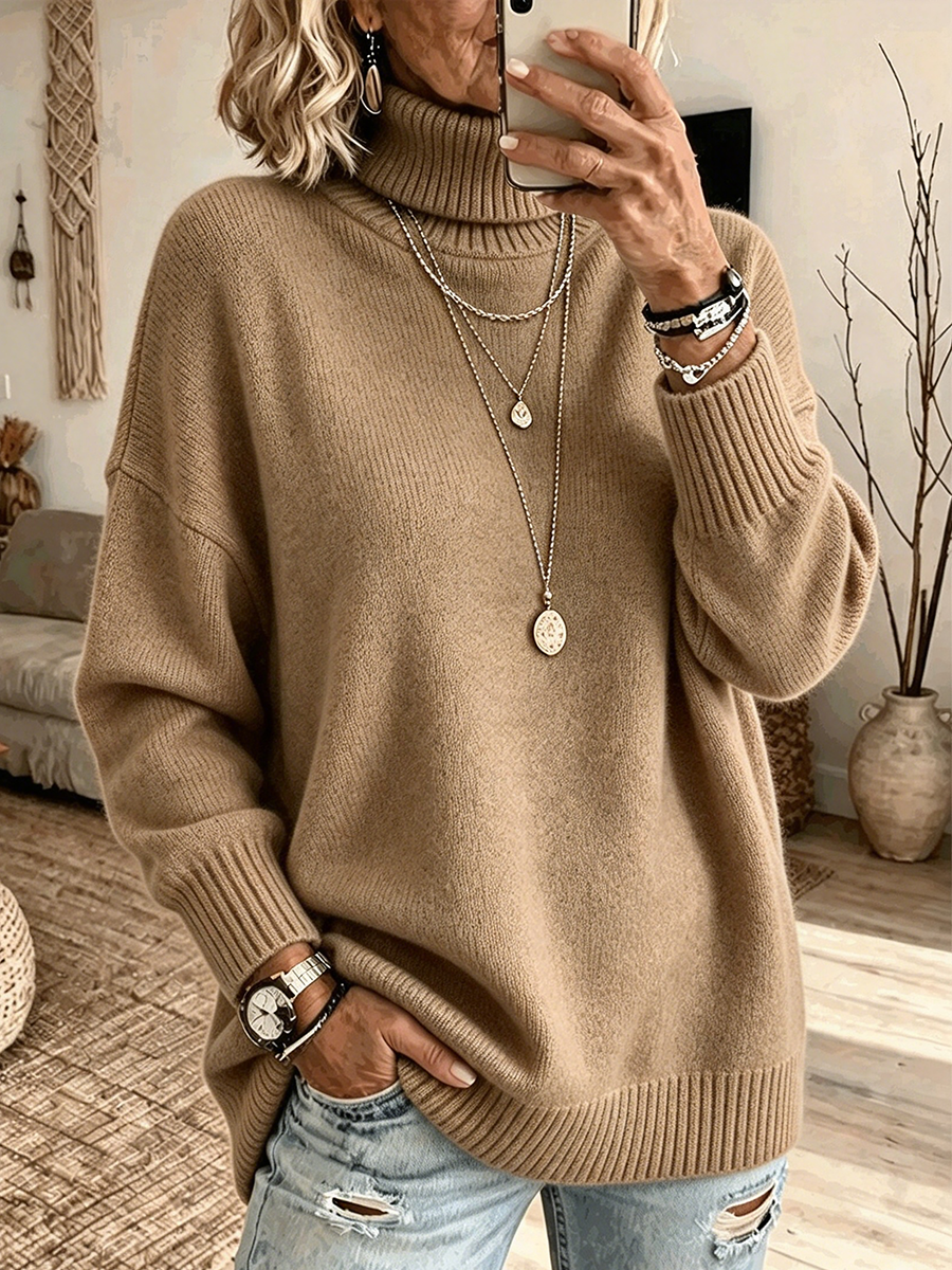 Camel turtleneck sweater with dropped shoulders, worn with ripped denim