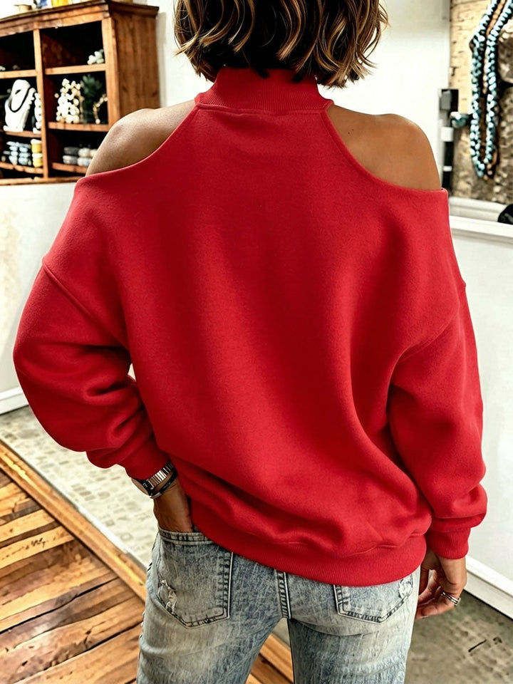 Back of the red sweatshirt showing the open shoulders and relaxed fit