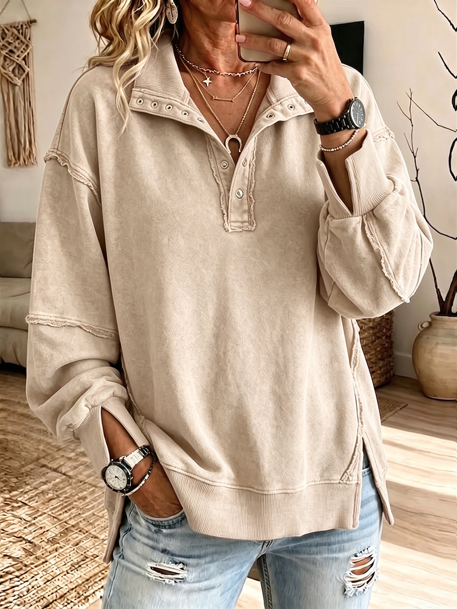 Beige dropped-shoulder sweatshirt with exposed seams along the sleeves