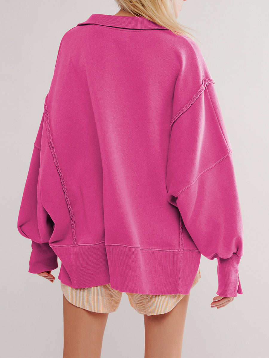 Back view of the hot pink sweatshirt showing raw-edge seams and roomy sleeves