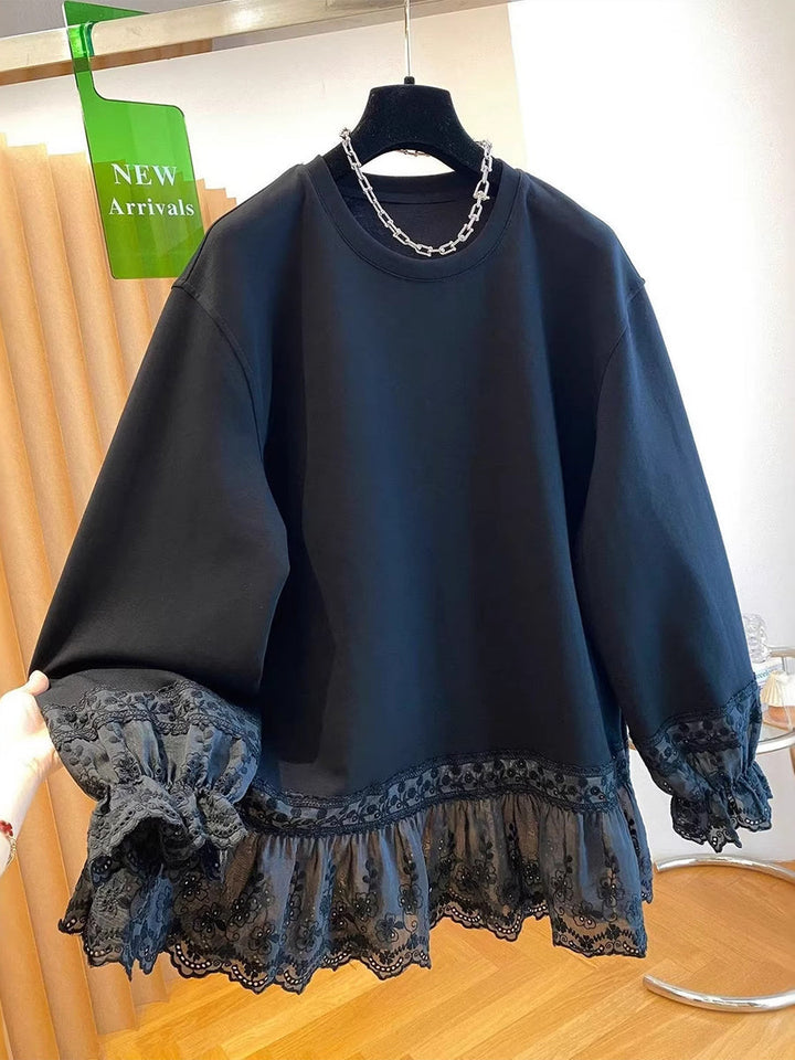 Black sweatshirt on a hanger with embroidered lace band and frilled cuffs
