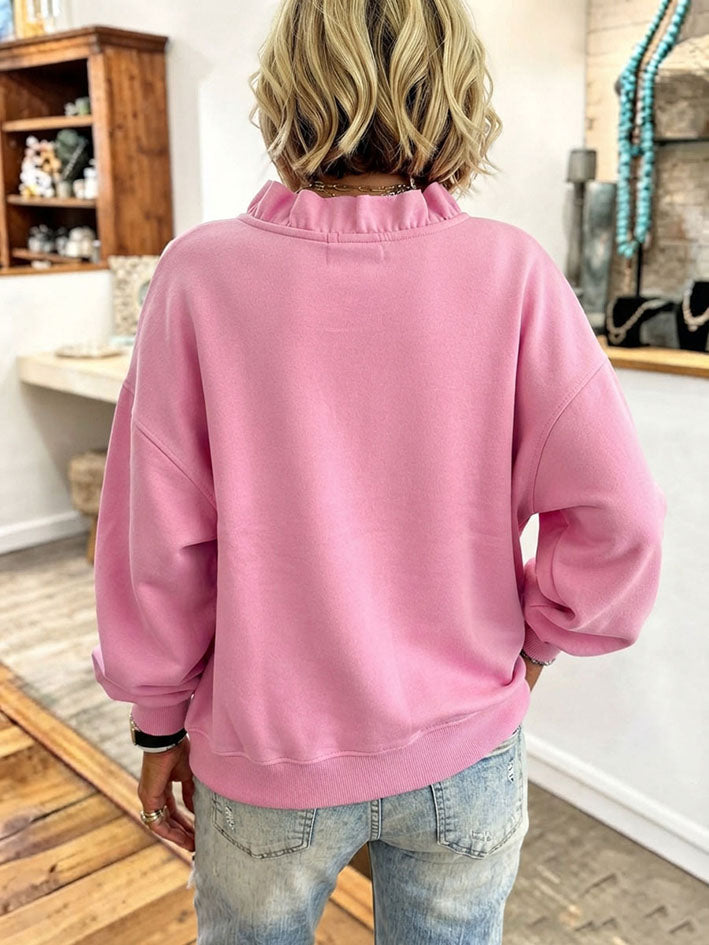 Back view of the pink sweatshirt with drop shoulders and ribbed hem