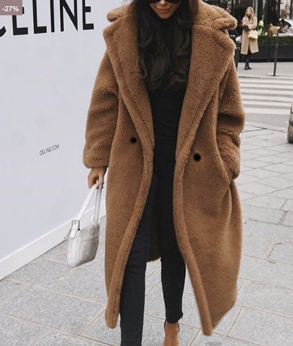Women's oversized teddy coat in brown with wide lapels, worn open on a city street