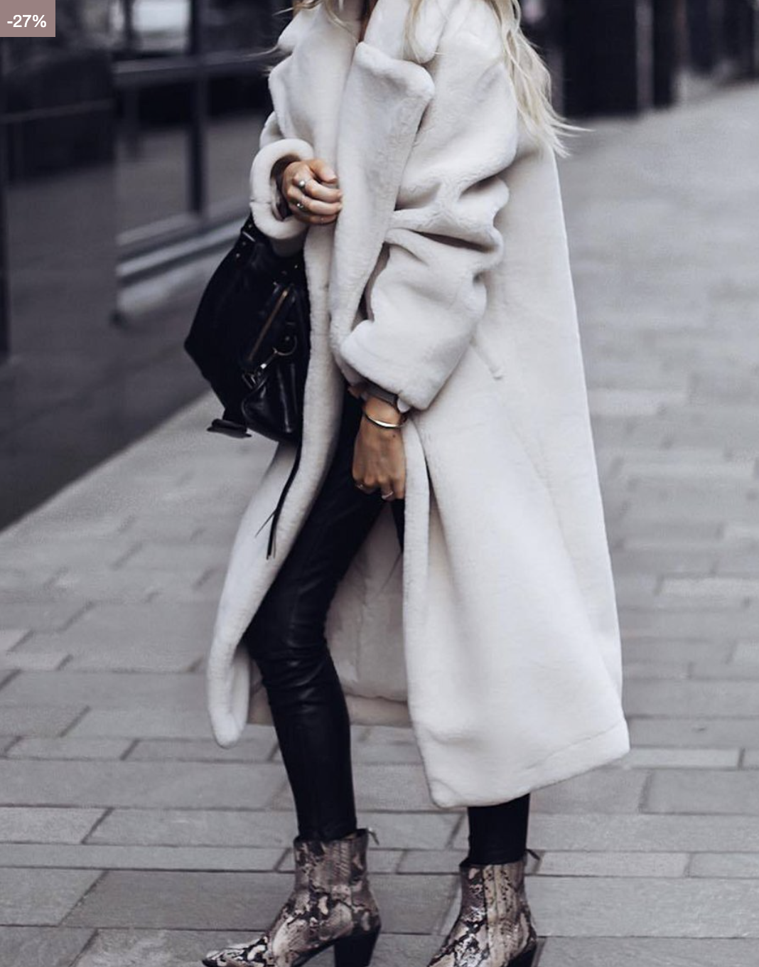 Ivory long plush coat with lapels styled with black pants and snakeskin ankle boots