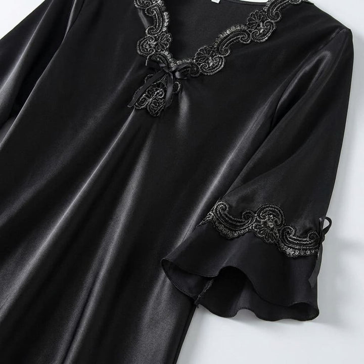 Close-up of the black V neck with lace trim and sleeve detail