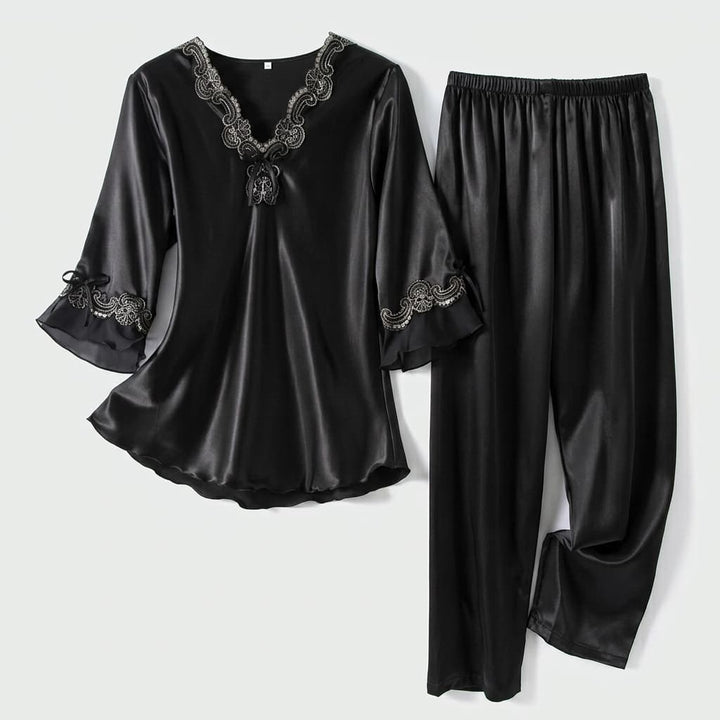 Black satin-look pajama top and pants laid flat