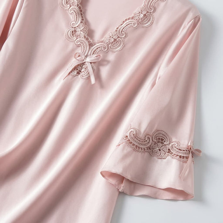 Close-up of the light pink V neck with lace trim and sleeve detail