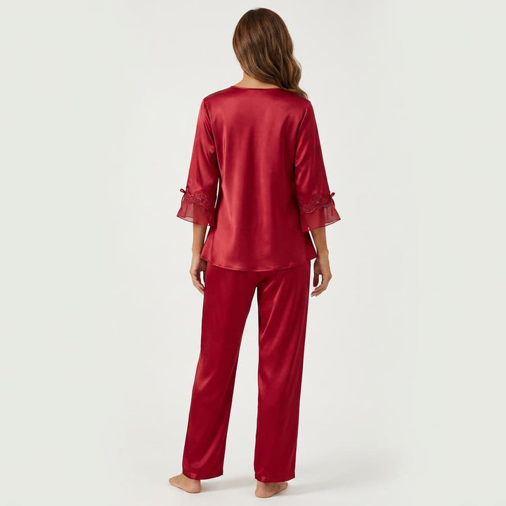 Back view of the red satin-look pajama set on a model
