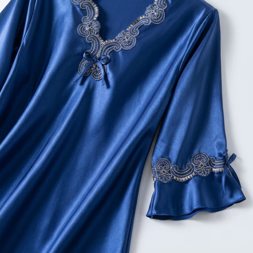 Close-up of the royal blue V neck with lace trim and sleeve detail