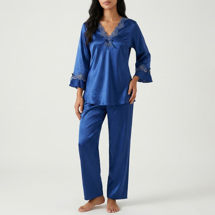 Woman wearing the royal blue satin-look pajama set with lace trim, front view