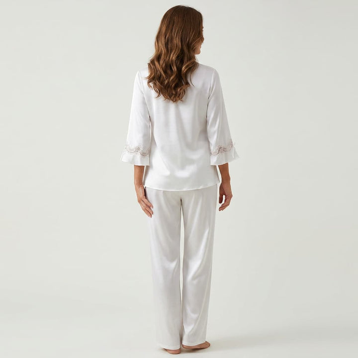 Back view of the white satin-look pajama set on a model