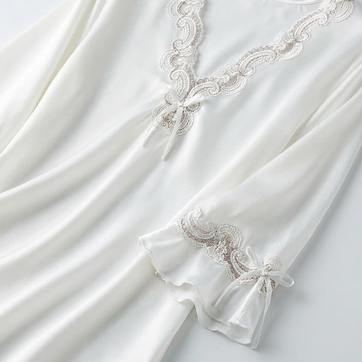 Close-up of the white V neck with lace trim and sleeve detail