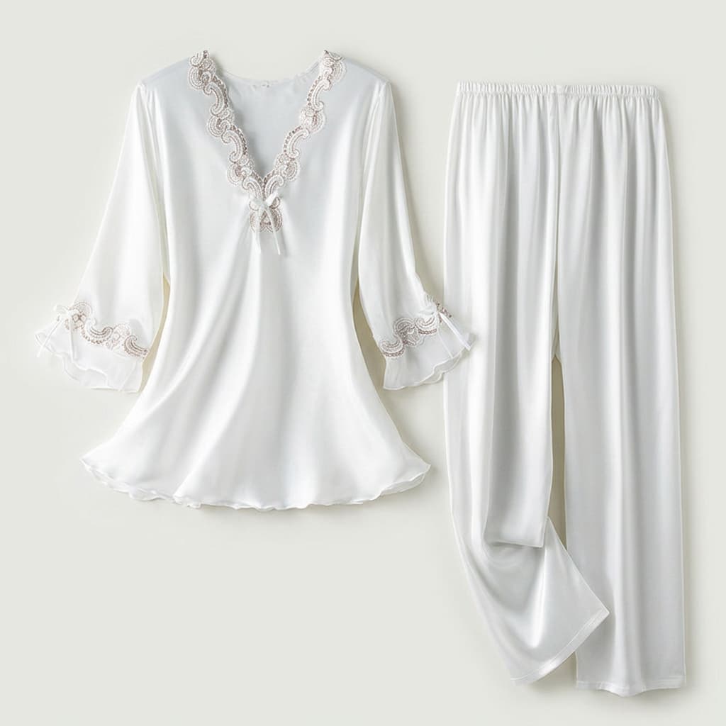 White satin-look pajama top and pants laid flat