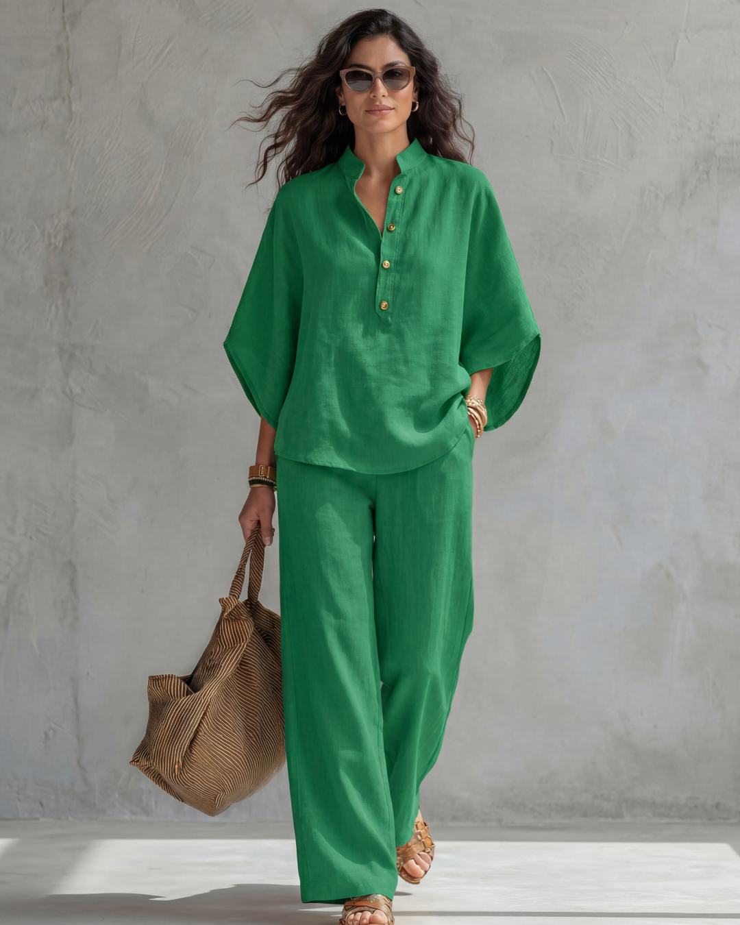Green button blouse with matching wide leg pants, model carrying a brown bag