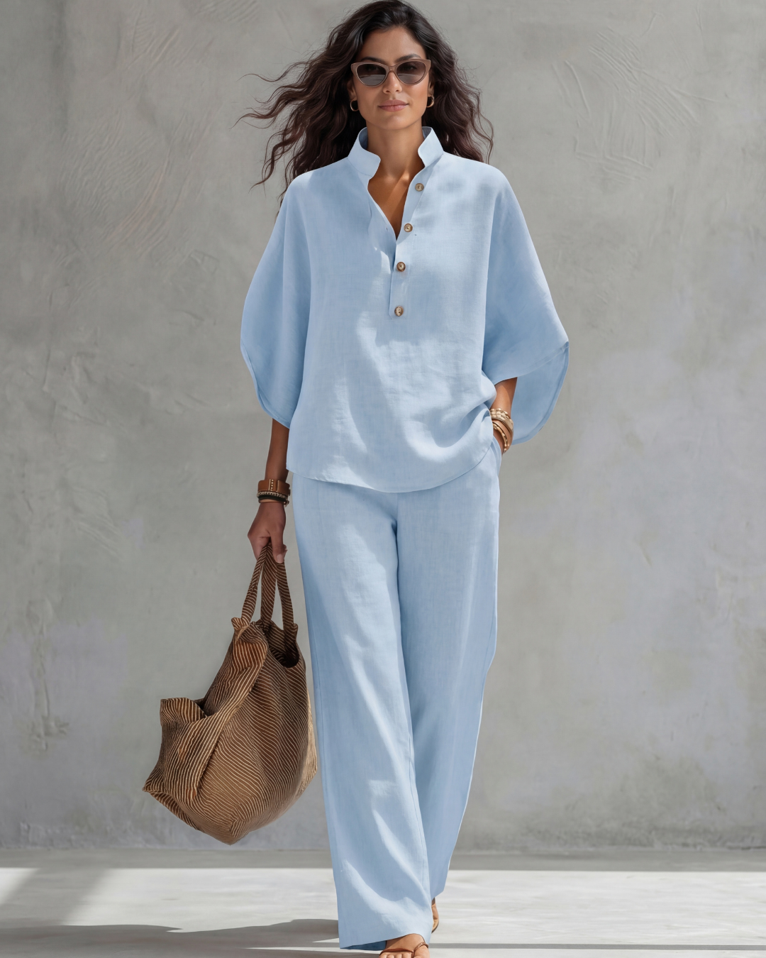 Light blue loose blouse and wide leg pants set on a model walking