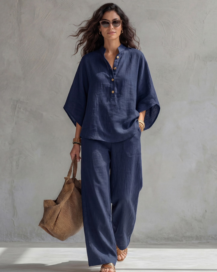 Navy blouse and wide leg pants set with a brown tote, full-length front view