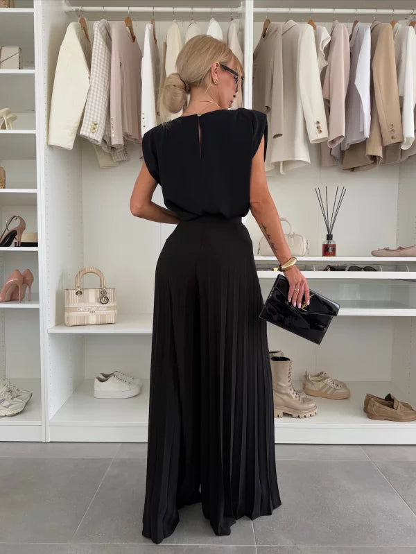Black pleated wide leg pants set from behind, with fitted sleeveless top