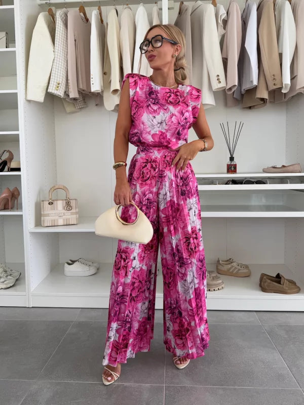 Fuchsia floral sleeveless top and pleated wide leg pants set, styled with cream clutch