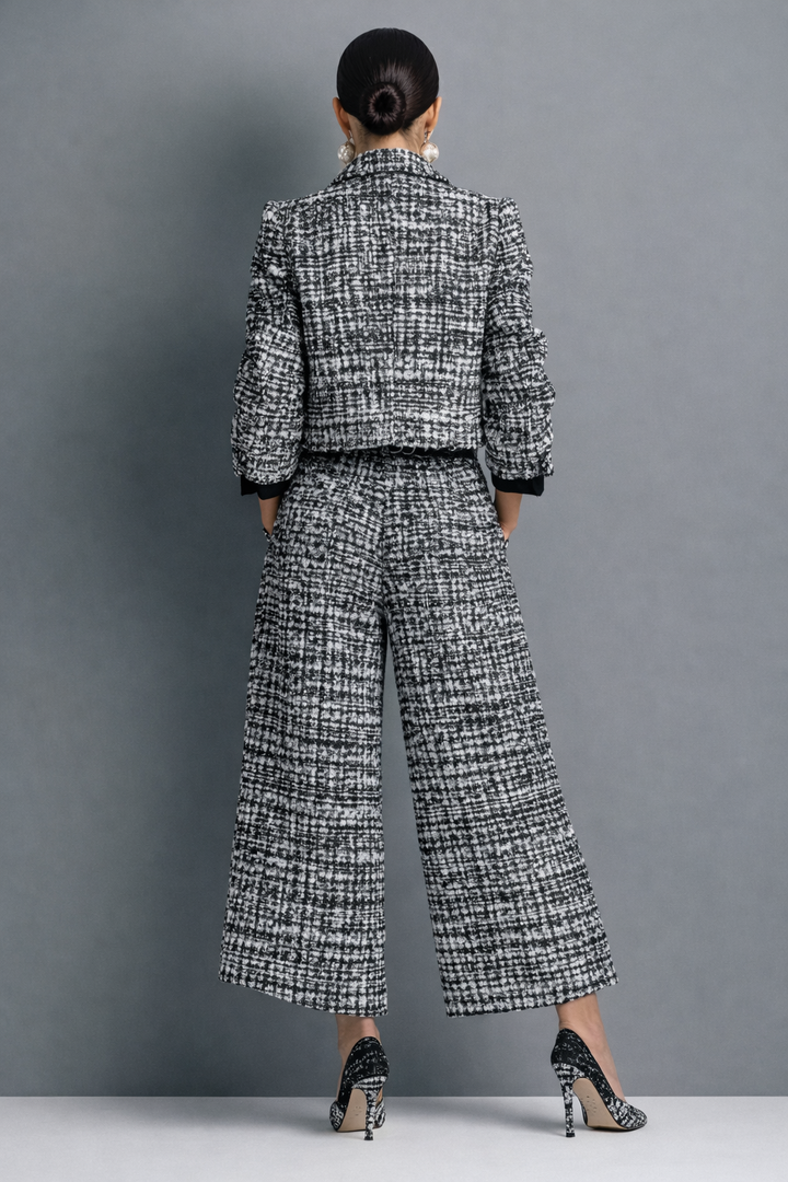 Back view of the black cropped jacket and wide leg pants set