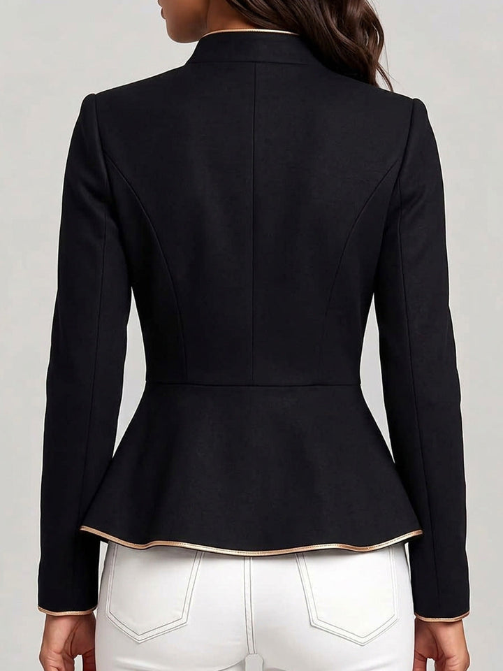 Back view of the black jacket showing the shaped seams and flared peplum hem