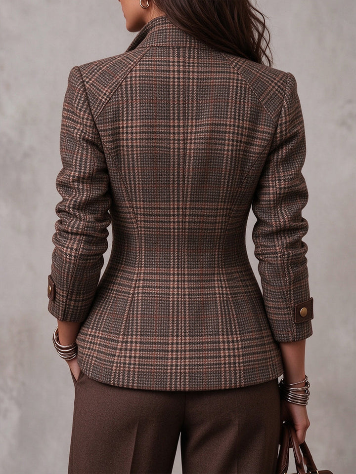 Back view of the plaid jacket showing raglan sleeves and a shaped waist