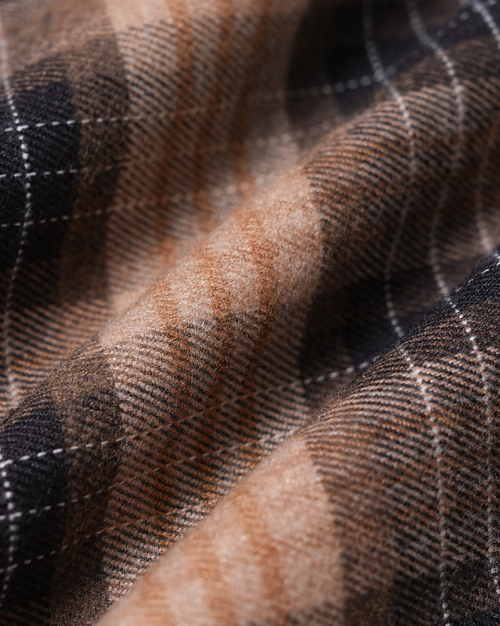 Close up of the brown, black and cream plaid fabric