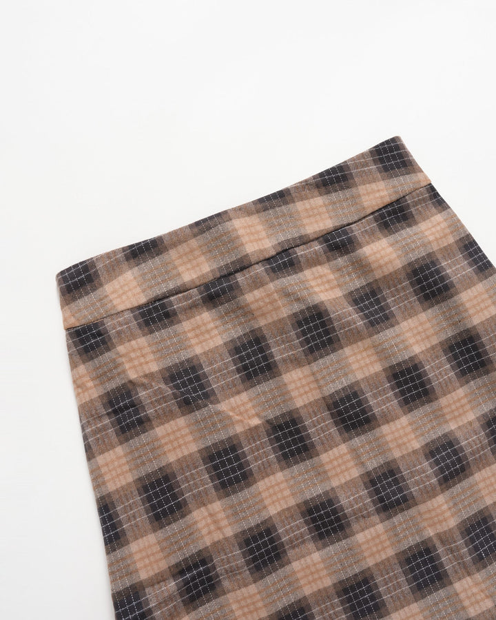 Folded corner of the brown plaid mini skirt showing the checked pattern