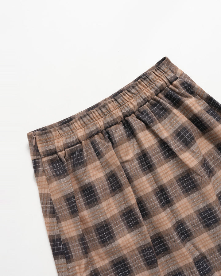 Folded brown plaid mini skirt showing the gathered elastic waist
