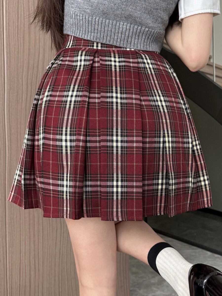Back view of the high waist pleated plaid skirt with gray knit vest