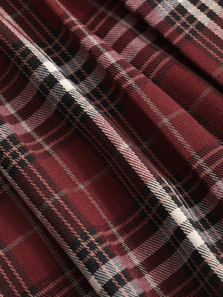 Close-up of burgundy plaid fabric with black and white check lines
