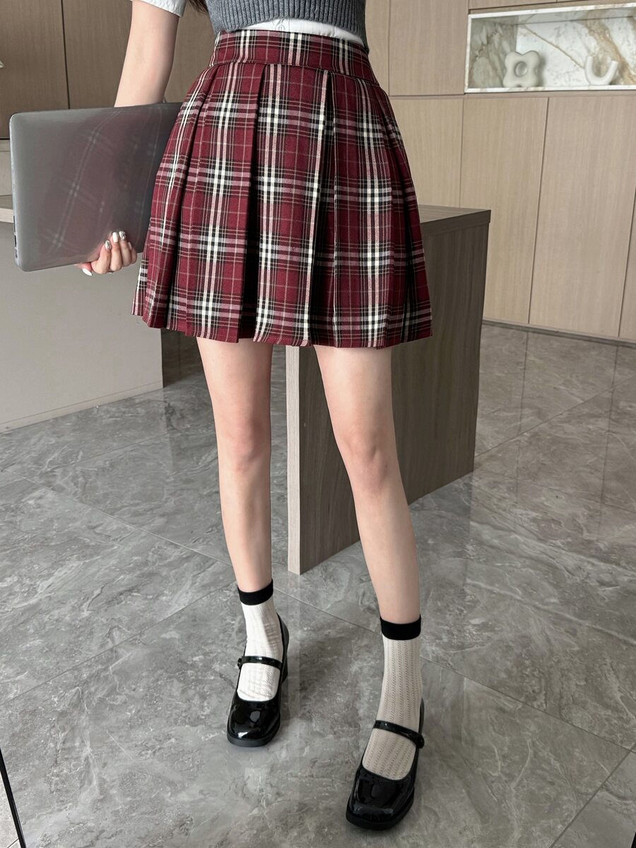 Plaid mini skirt styled with white socks and black Mary Jane shoes