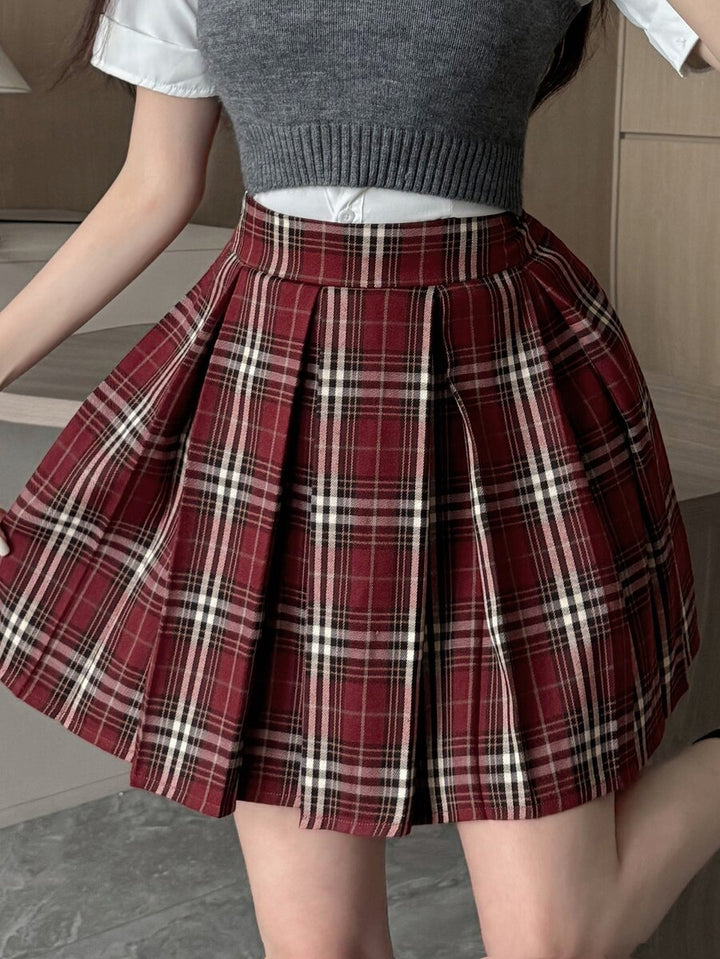 Burgundy pleated plaid mini skirt with a white tee, angled front view