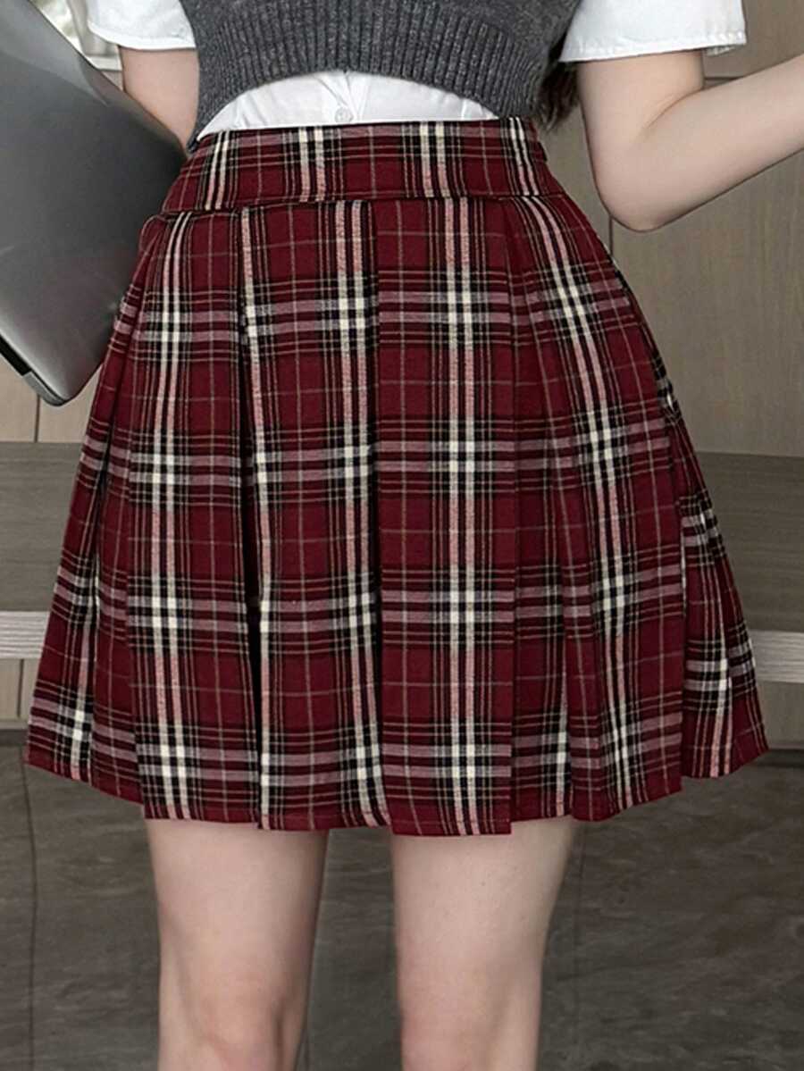 Pleated plaid mini skirt in red and white check worn with a gray vest