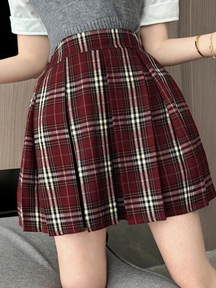 Side view of the red plaid pleated mini skirt on model