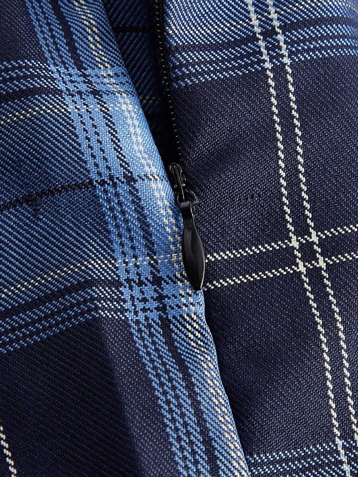 Detail of the side zipper and plaid pattern on the pleated skirt