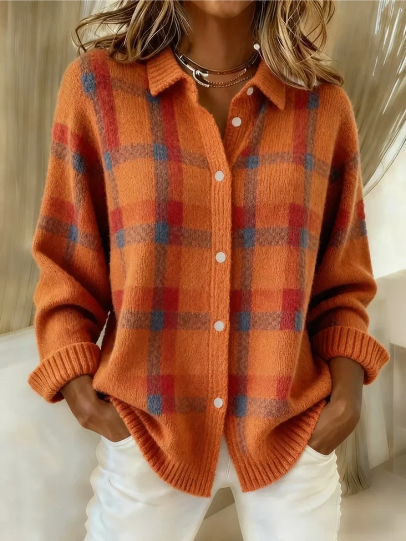 Orange plaid knit shacket with collar and ribbed cuffs, hands in pockets