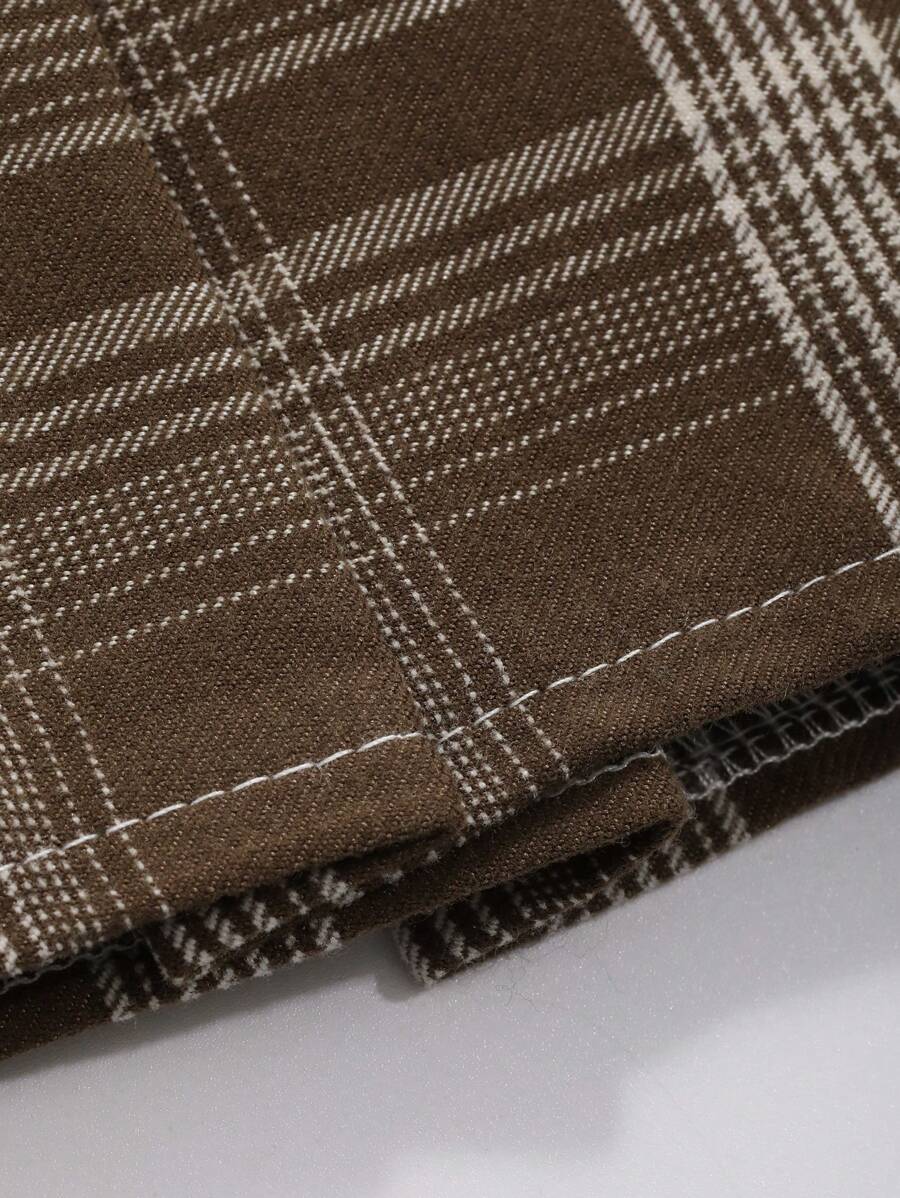 Close-up of brown plaid fabric with light checks and stitched hem