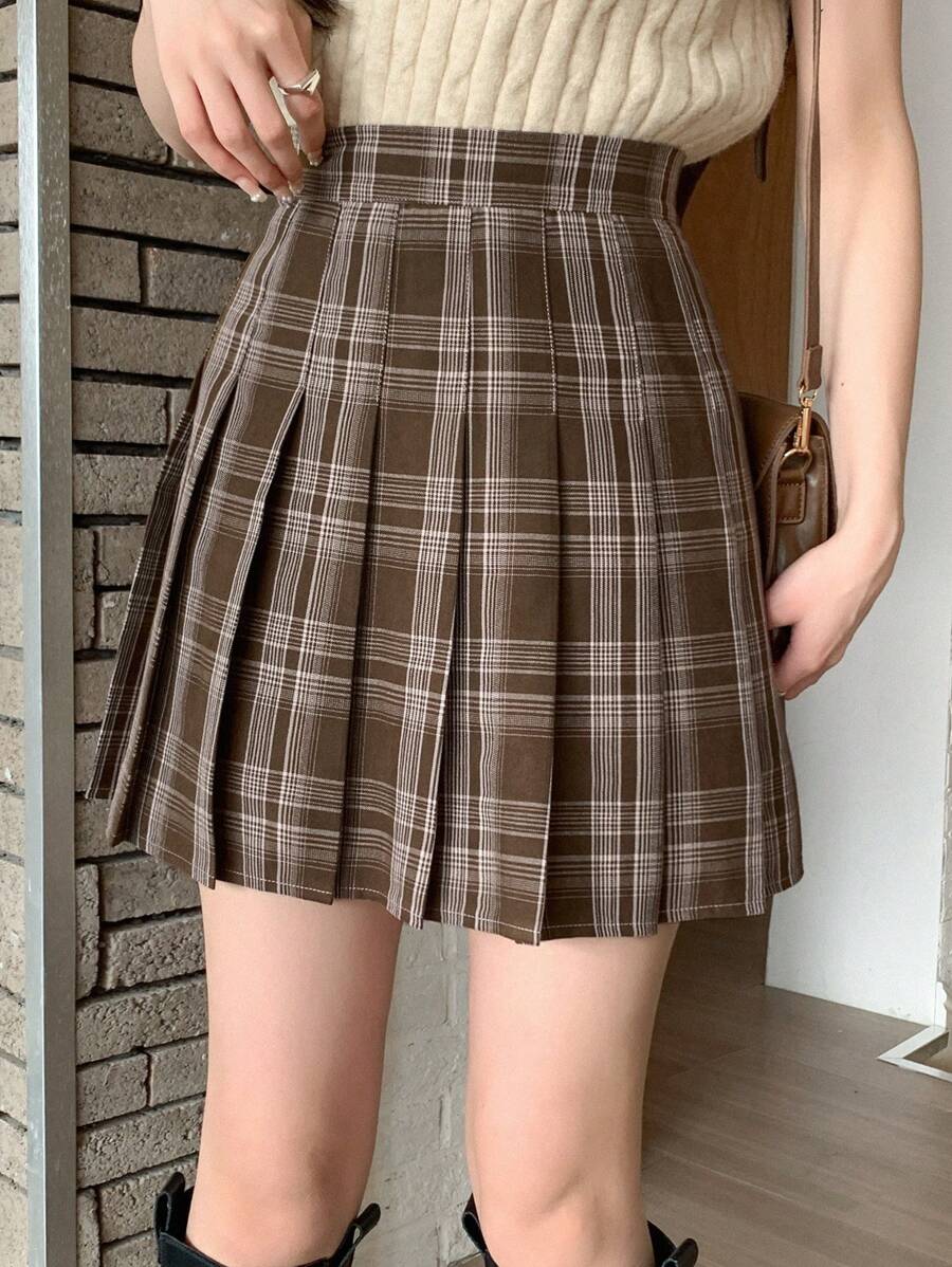 Side view of the pleated plaid mini skirt showing the pleat detail