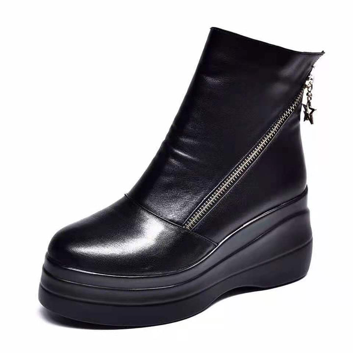 Black platform wedge ankle boot with diagonal zip on a white background